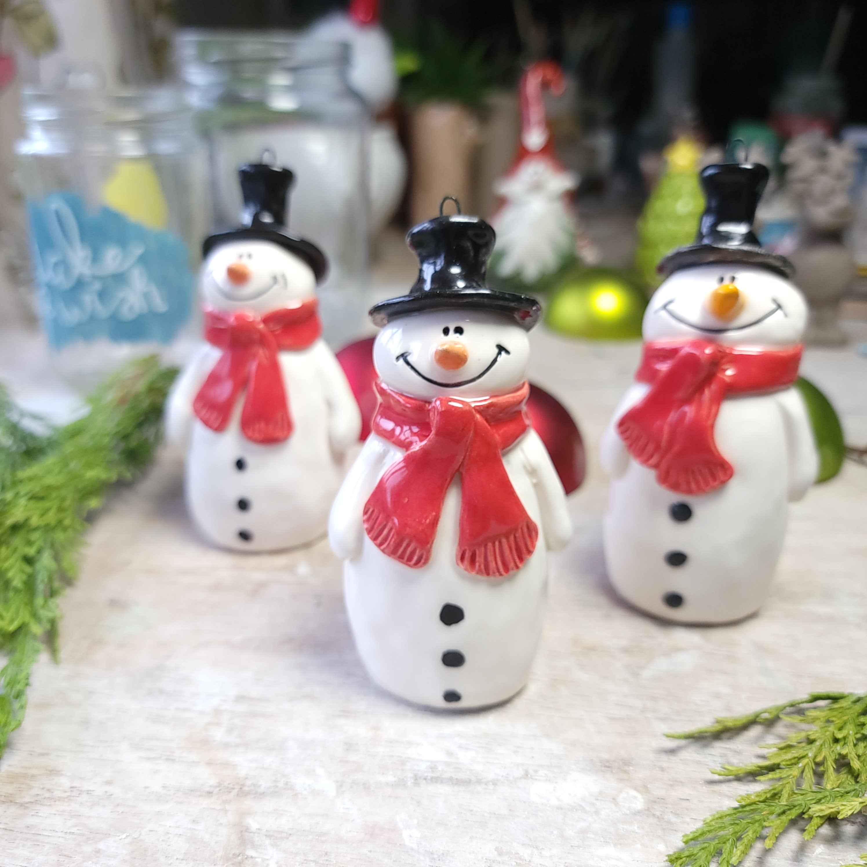 Christmas snowmen with festive red scarves decoration.