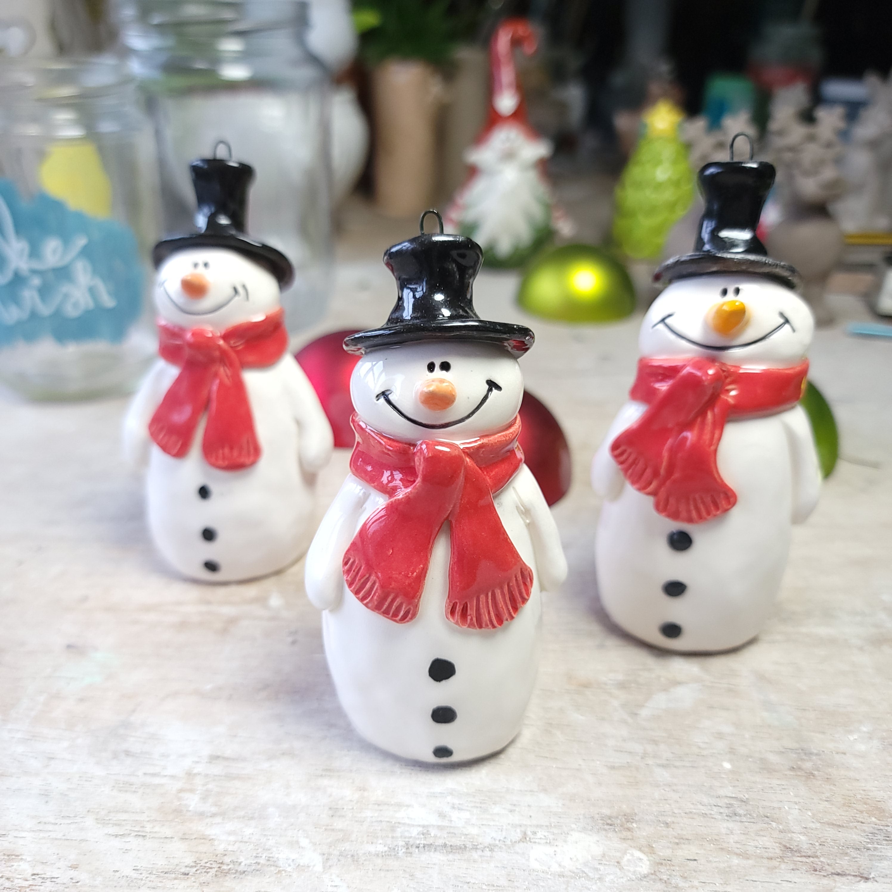 Christmas snowmen with festive red scarves decoration.