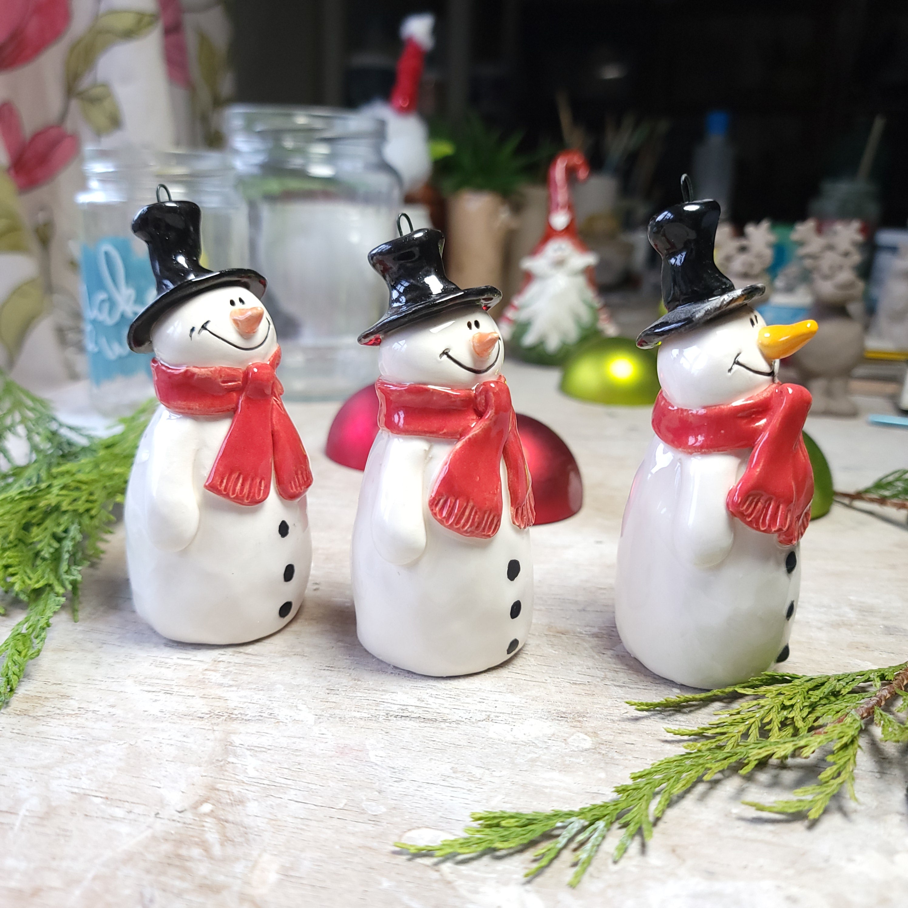 Christmas snowmen with festive red scarves decoration.