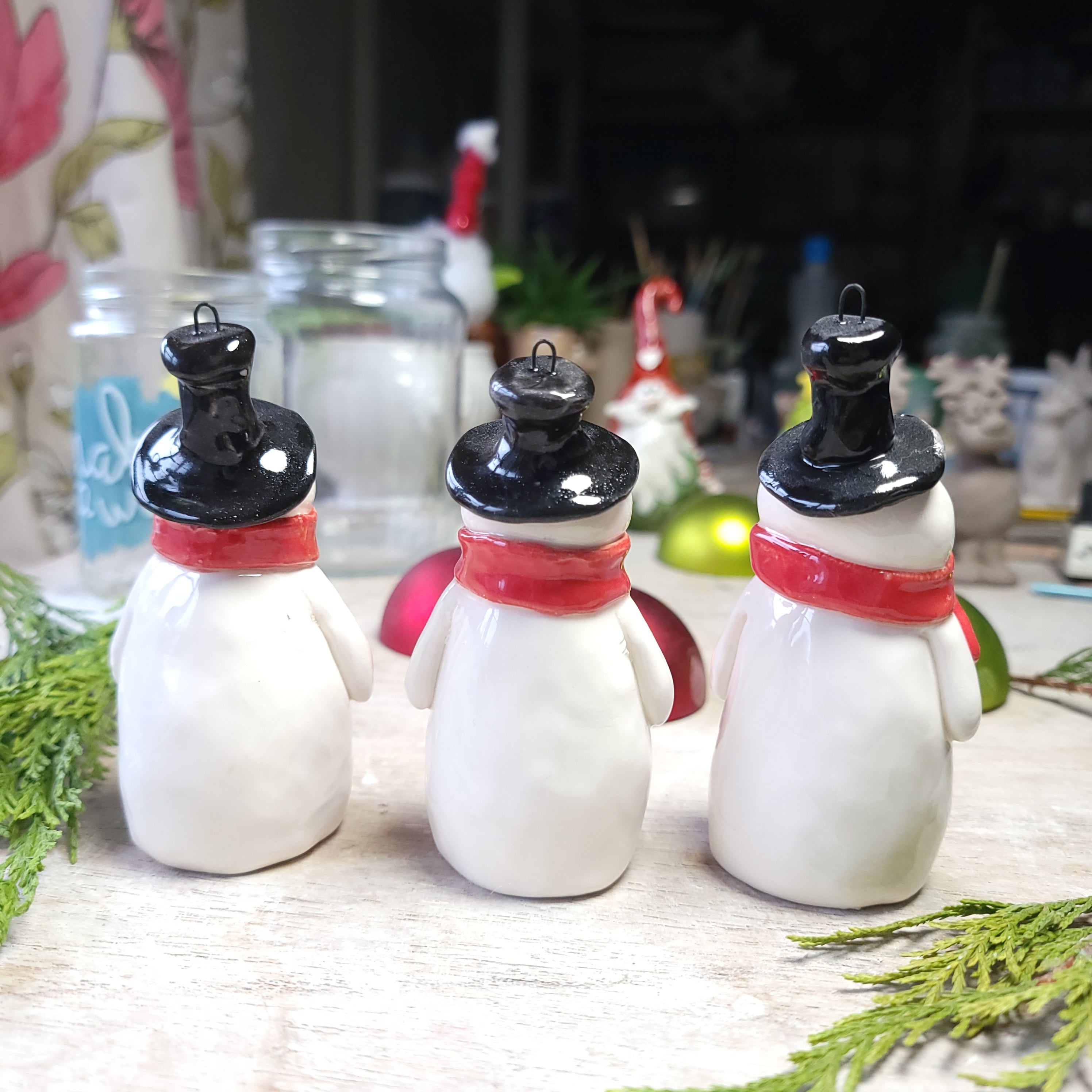 Christmas snowmen with festive red scarves decoration.